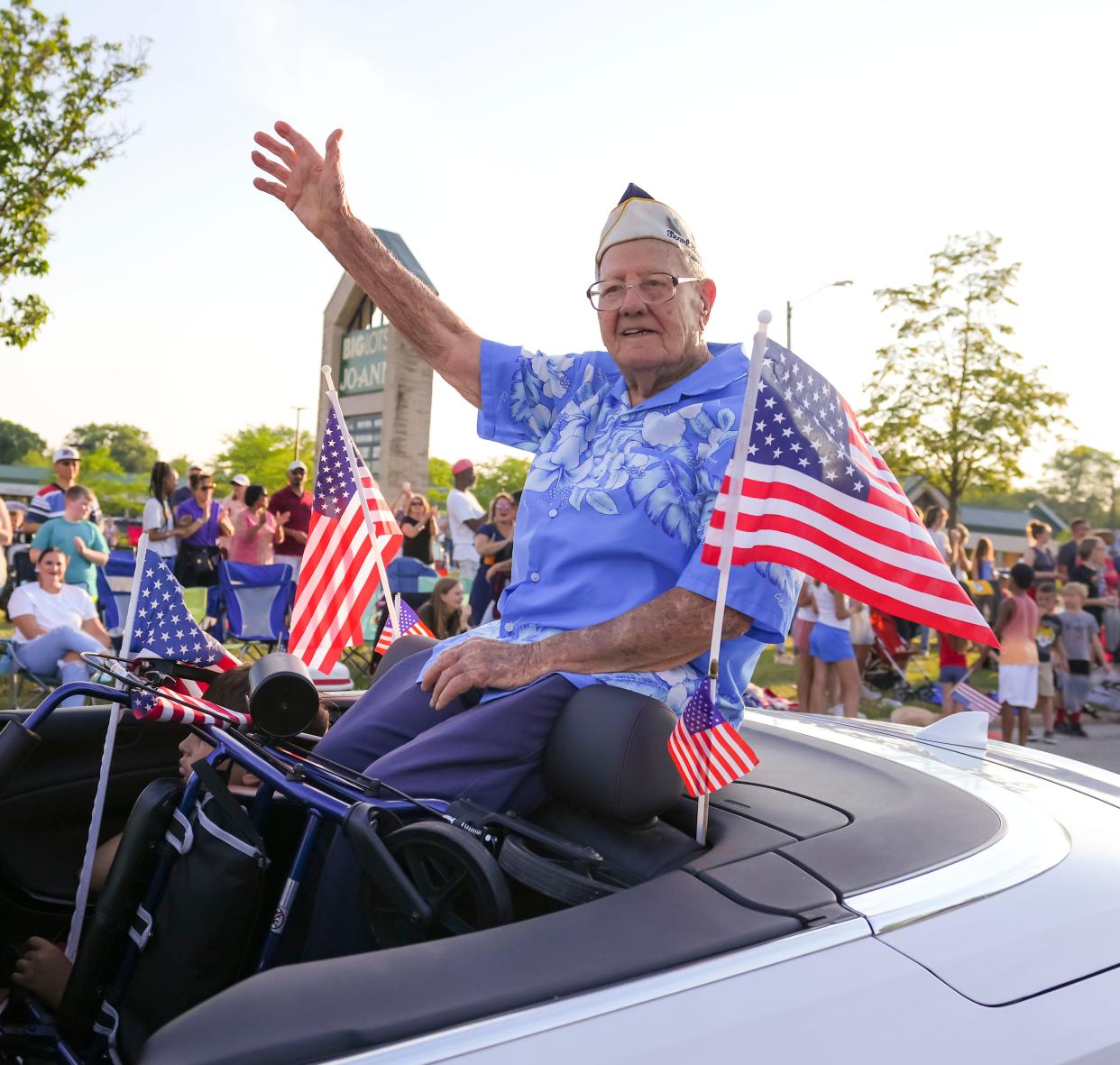 Pearl Harbor survivor Edward Miklavcic, a veteran of the then U.S. Army Air Forces, rides in the annual Menomonee Falls Independence Day parade on Sunday, July 3, 2022.
