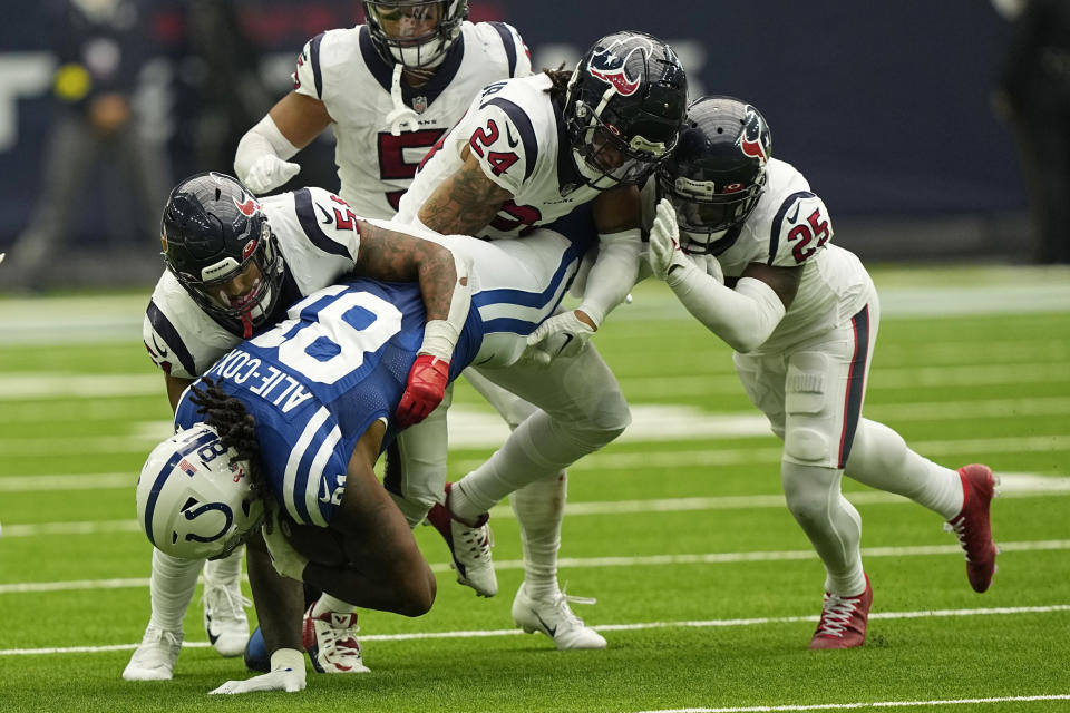 Indianapolis Colts tight end Mo Alie-Cox (81) hangs onto a pass as Houston Texans linebacker Kamu Grugier-Hill (51) teammate cornerback Derek Stingley Jr. (24) and cornerback Desmond King II (25) make the stop uring the second half of an NFL football game Sunday, Sept. 11, 2022, in Houston. (AP Photo/David J. Phillip)