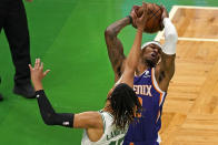 Phoenix Suns forward Torrey Craig (12) controls a rebound against Boston Celtics guard Romeo Langford (45) in the first half of an NBA basketball game, Thursday, April 22, 2021, in Boston. (AP Photo/Elise Amendola)