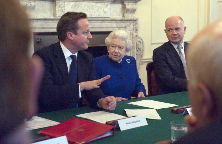 Britain's Queen Elizabeth and Foreign Secretary William Hague (R) listen as Prime Minister David Cameron makes introductory remarks at a Cabinet meeting, December 18, 2012. Lawmakers from Cameron's Conservative Party will on Wednesday issue a "manifesto" spelling out the sweeping changes that need to be made to keep Britain in the European Union