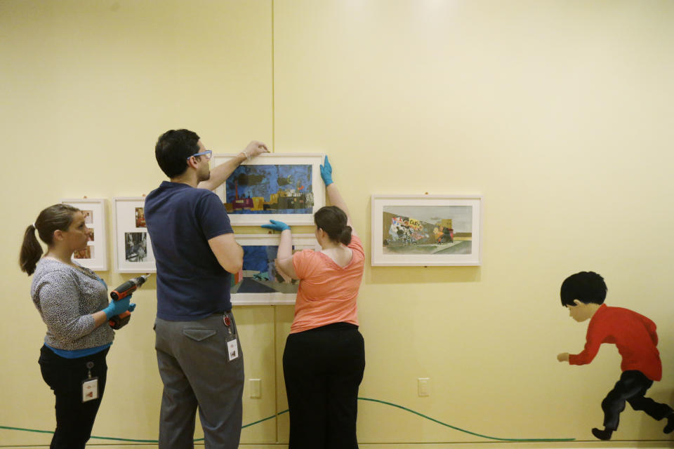 In this Wednesday, July 10, 2013 photo, perorations are made for The Snowy Day and The Art Of Ezra Jack Keats exhibition at the National Museum of American Jewish History, in Philadelphia. The exhibition opened July 19. (AP Photo/Matt Rourke)