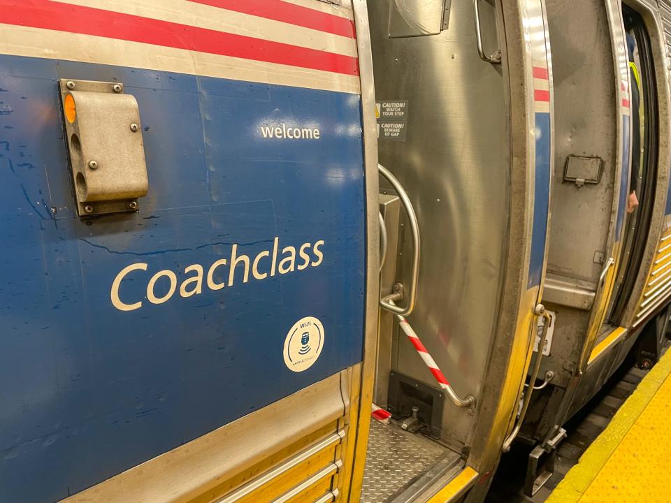 The exterior of the coach class on the Northeast Regional Amtrak train.