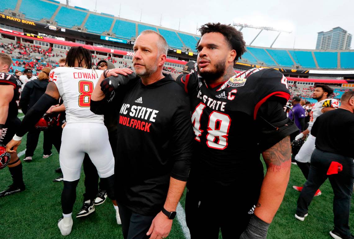 “I love you coach” says defensive tackle Cory Durden (48) to N.C. State head coach Dave Doeren. “I love you” Doeren responds as they walk off after Maryland’s 16-12 victory over N.C. State in the Duke’s Mayo Bowl at Bank of America Stadium in Charlotte, N.C., Friday, Dec. 30, 2022.