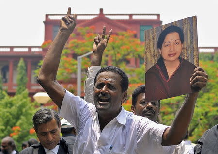 Lawyers from the Karnataka High Court hold a portrait of Jayalalithaa Jayaram, former chief minister of Tamil Nadu state and chief of her AIADMK party, during celebrations outside a court in Bengaluru, India, May 11, 2015. REUTERS/Abhishek N. Chinnappa