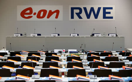 FILE PHOTO: The logos of RWE and E.ON are seen before a joint news conference of the two German utilities after unveiling plans for an asset swap deal which will break up RWE's Innogy unit in Essen, Germany, March 13, 2018. REUTERS/Wolfgang Rattay/File Photo