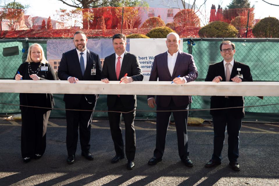 Signing the final steel beam for the new addition of Robert Wood Johnson University Hospital Somerset are Donna Castronovo, vice president, Somerset Health Care Foundation; Patrick Delaney, chief administrative officer, Robert Wood Johnson University Hospital Somerset; Bill Arnold, executive vice president, RWJBarnabas Health, president, RWJBarnabas Health Southern Region and president and CEO, Robert Wood Johnson University Hospital; Jack Morris, chairman, Robert Wood Johnson University Hospital Board of Directors; and orthopedic surgeon Stephen Kayiaros, medical director, Joint Surgery Program, Robert Wood Johnson University Hospital Somerset.