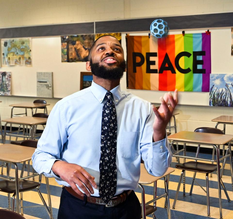 Sandwich Middle-High School history teacher Andre King, who identifies as African American, tosses a ball Monday in his classroom. King's contract for the upcoming school year is not renewed, which he said is discriminatory. "Diversity in education is tied to academic achievement," he said.