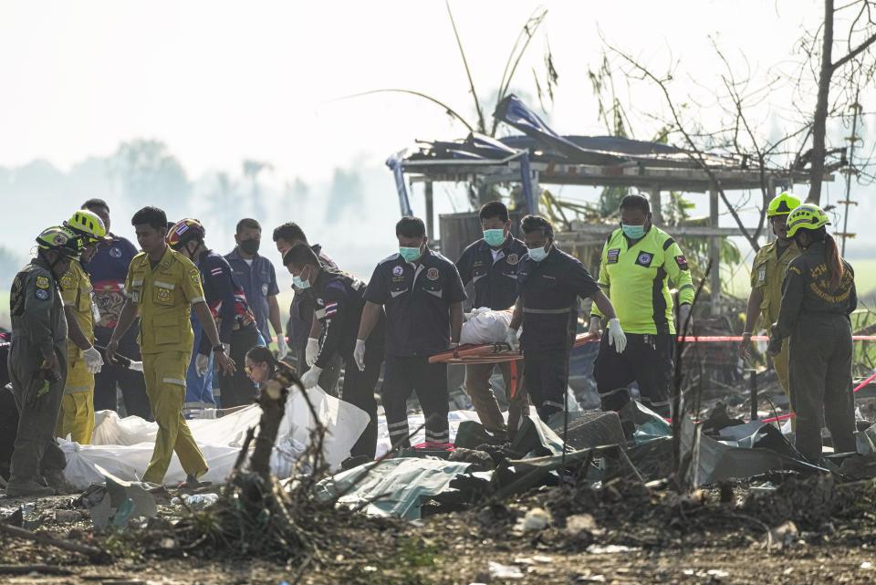 Thai rescue workers carry the body of a victim from the site of an explosion at a fireworks factory in Suphan Buri province, Thailand, Thursday, Jan. 18, 2024. The blast in central Thailand killed multiple people on Wednesday, according to provincial officials, though the devastation at the scene has made the death toll uncertain. (AP Photo/Sakchai Lalit)