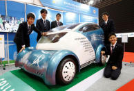 Students from Aichi Highschool of Technology and Engineering pose next to their developed electric vehicle named Collapse during media preview of the 45th Tokyo Motor Show in Tokyo, Japan October 25, 2017. REUTERS/Toru Hanai