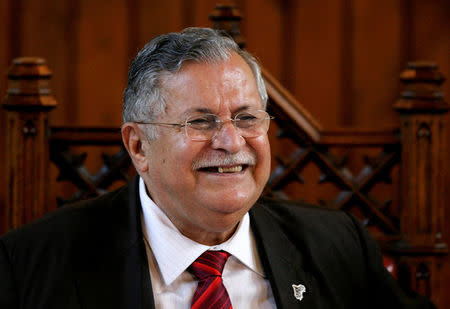 FILE PHOTO: Iraq's President Jalal Talabani smiles as he attends a debate meeting with university students at the Cambridge Union Society in Cambridge, eastern England, May 11, 2007. REUTERS/Alessia Pierdomenico/File Photo