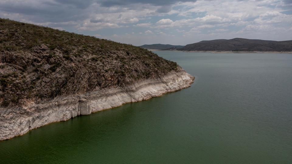 A water line is visible in Toronto Lake upstream of La Boquilla Dam, in San Francisco de Conchos, Chihuahua. The dam generates hydroelectricity and provides irrigation water. La Boquilla Dam and Lake Toronto photographed with a drone in August 2023. According to Mexico's water agency, the reservoir was at 44% capacity.