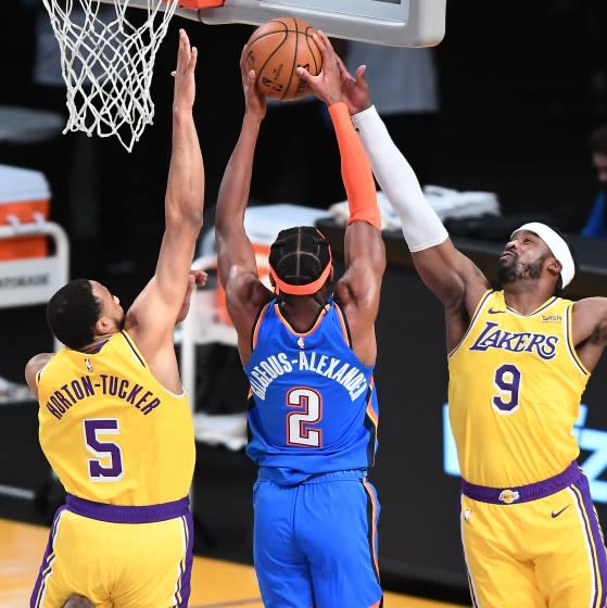 LOS ANGELES, CALIFORNIA FEBRUARY 8, 2021-Lakers Wesley Matthews (9) blocks the shot of Thunders Shai Gilgeous-Alexander as Talen Horton-Tucker helps on defense in the first quarter at the Staples Center Monday. (Wally Skalij/Los Angeles Times)