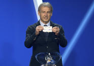 Juergen Klinsmann, former soccer player and soccer official, holds the lot of The Netherlands during the draw for the groups to qualify for the 2024 European soccer championship in Frankfurt, Germany, Sunday, Oct.9, 2022. (Arne Dedert/dpa via AP)