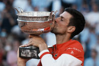 Serbia's Novak Djokovic kisses the cup after defeating Stefanos Tsitsipas of Greece in their final match of the French Open tennis tournament at the Roland Garros stadium Sunday, June 13, 2021 in Paris. Djokovic won 6-7, 2-6, 6-3, 6-2, 6-4. (AP Photo/Thibault Camus)