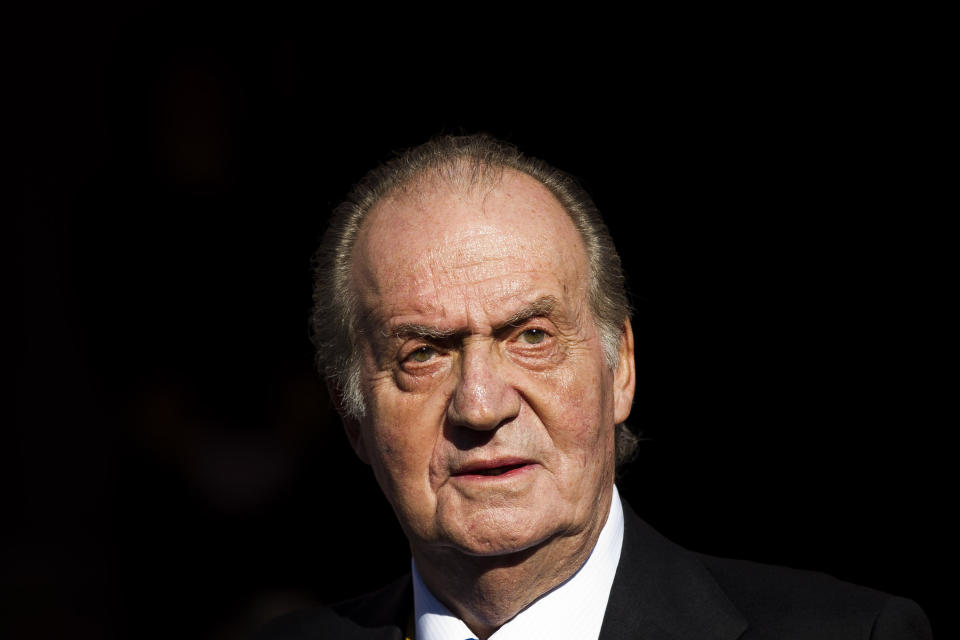 FILE - Spain's King Juan Carlos leaves after the official opening of the Parliament, in Madrid, Tuesday, Dec. 27, 2011. Juan Carlos I, now 86, abdicated in disgrace in 2014. He had once been so popular that many Spaniards would say that they were “not monarchists, but Juan Carlists.” (AP Photo/Daniel Ochoa de Olza, File)