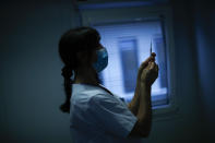 A nurse prepares a syringe with Pfizer/Biontech COVID-19 vaccine as medical workers are vaccinated at the MontLegia CHC hospital in Liege, Belgium, Wednesday, Jan. 27, 2021. The 27-nation EU is coming under criticism for the slow rollout of its vaccination campaign. The bloc, a collection of many of the richest countries in the world, is not faring well in comparison to countries like Israel, the United Kingdom and the United States. (AP Photo/Francisco Seco)