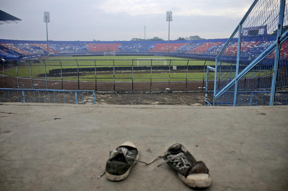 A pair of sneakers sit trampled in the stands of Kanjuruhan Stadium following a deadly soccer match stampede, in Malang, East Java, Indonesia, Sunday, Oct. 2, 2022. Panic at an Indonesian soccer match after police fired tear gas to to disperse supporters invading the pitch left over 100 people dead, mostly trampled to death, police said Sunday. (AP Photo/Hendra Permana)