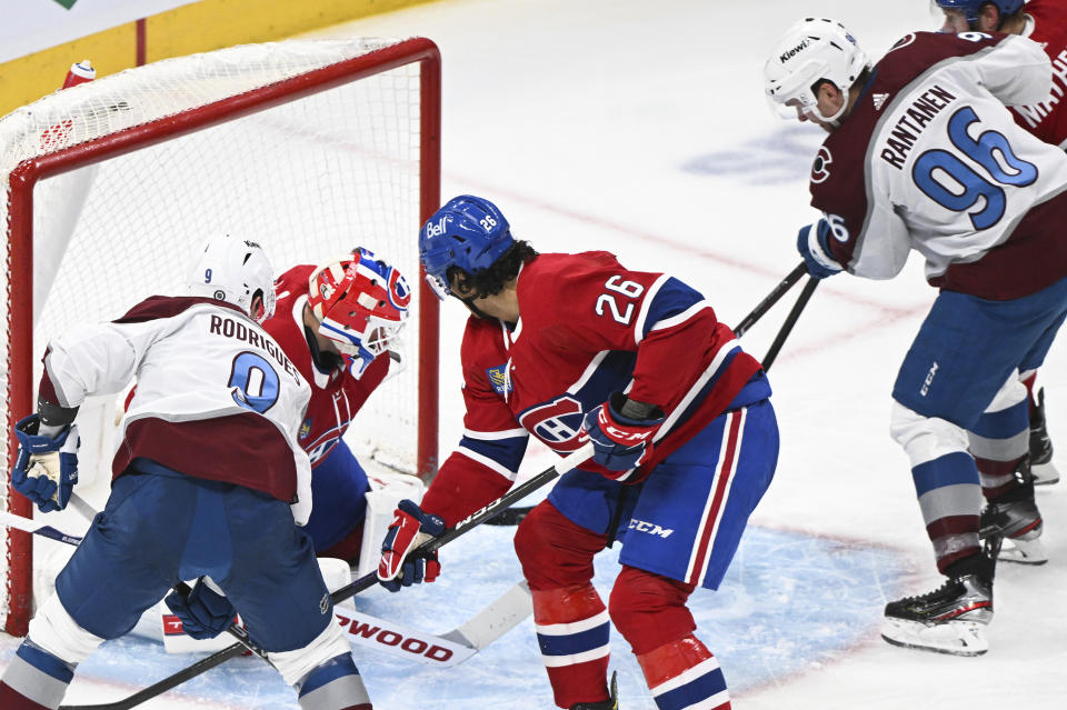 Colorado Avalanche's Mikko Rantanen (96) scores against Montreal Canadiens goaltender Jake Allen as Avalanche's Evan Rodrigues (9) and Canadiens' Johnathan Kovacevic (26) look on during second-period NHL hockey game action in Montreal, Monday, March 13, 2023. (Graham Hughes/The Canadian Press via AP)