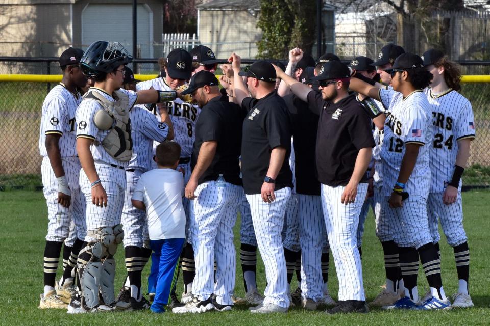 The Harry S. Truman baseball team huddles after a 6-4 comeback win over Archbishop Wood.