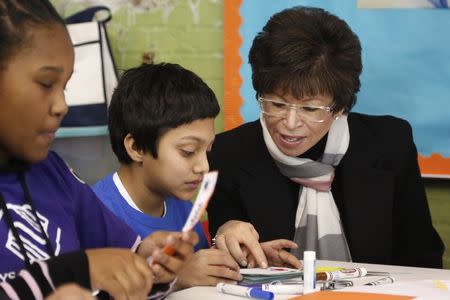 White House senior advisor Valerie Jarrett (R) joins U.S. President Barack Obama (not pictured) as they work with children during a day of service at the Boys & Girls Club of Greater Washington, in celebration of the Martin Luther King, Jr. holiday in Washington January 19, 2015. REUTERS/Jonathan Ernst