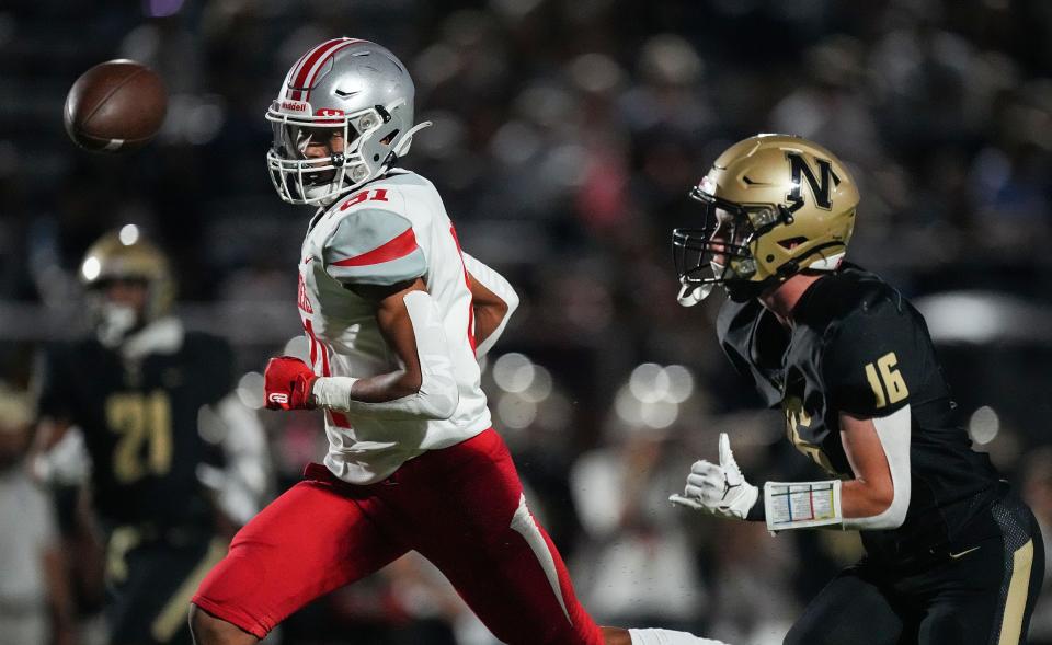 Fishers Tigers wide receiver JonAnthony Hall (81) rushes after the ball against Noblesville Millers cornerback Cole Schott (16) on Friday, Sept. 1, 2023, during the game at Noblesville High School in Noblesville. The Fishers Tigers defeated the Noblesville Millers, 48-22.