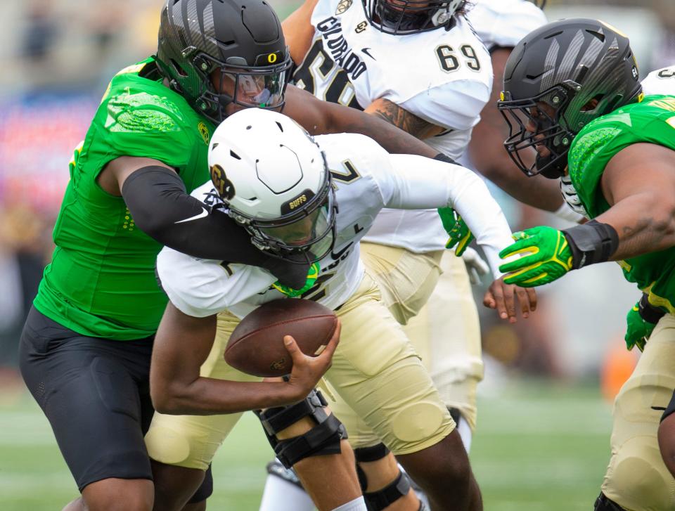 Oregon's Jordan Burch sacks Colorado quarterback Shedeur Sanders during the second quarter in Eugene in September 2023.