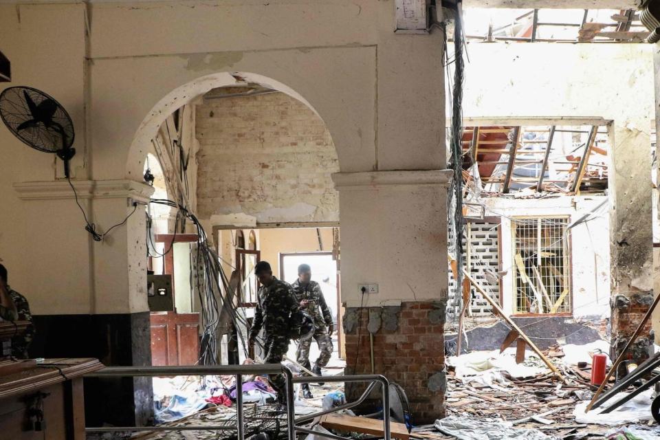 Sri Lanka security walk through the debris at St Anthony's Shrine church following an explosion (AFP/Getty Images)
