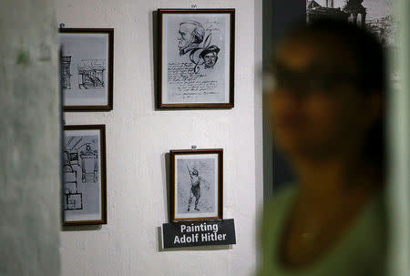A visitor watchs artifacts at the exhibition entitled 'Hitler - How Could it Happen?' about German Nazi leader Adolf Hitler during a media tour in a World War Two bunker in Berlin, Germany, July 27, 2017. REUTERS/Fabrizio Bensch