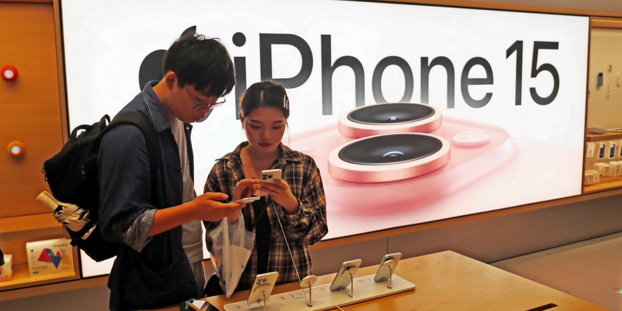 Customers trying out Apple's iPhone 15 at an Apple store in Shanghai, China.