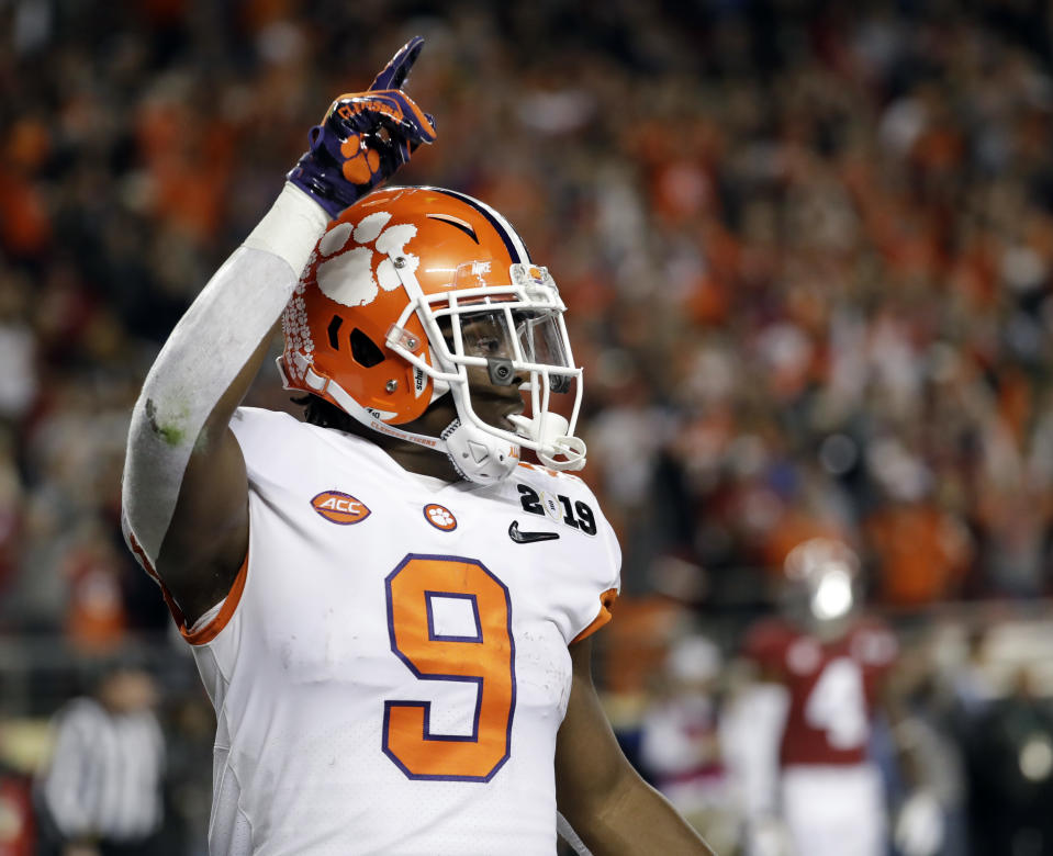 FILE - In this Jan. 7, 2019, file photo, Clemson's Travis Etienne celebrates his touchdown run during the first half the NCAA college football playoff championship game against Alabama, in Santa Clara, Calif. Clemson is preseason No. 1 in The Associated Press Top 25, Monday, Aug. 24, 2020, a poll featuring nine Big Ten and Pac-12 teams that gives a glimpse at what’s already been taken from an uncertain college football fall by the pandemic. (AP Photo/Chris Carlson, File)