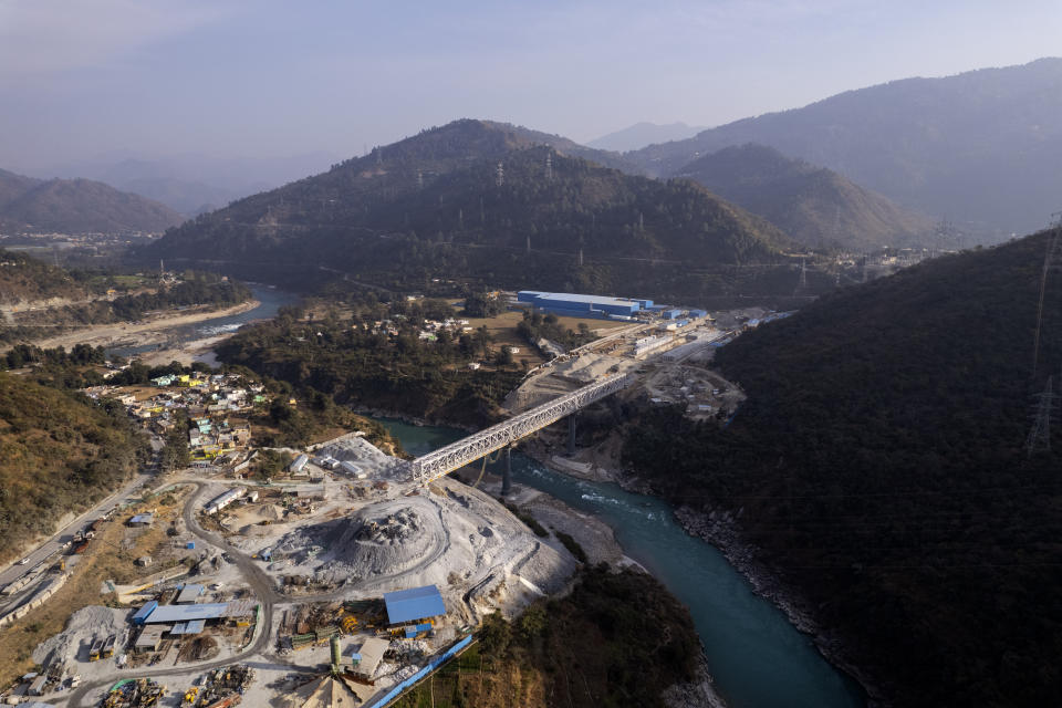 An ariel view of a construction site of one of the longest railway tunnels, spanning 15 kilometers (9 miles), which will be part of 125 kilometers (78 miles) long Rishikesh-Karanprayag line to connect the Char Dam pilgrimage, in Lachmoli village, in India's Himalayan mountain state of Uttarakhand, Jan.18, 2023. (AP Photo/Rajesh Kumar Singh)
