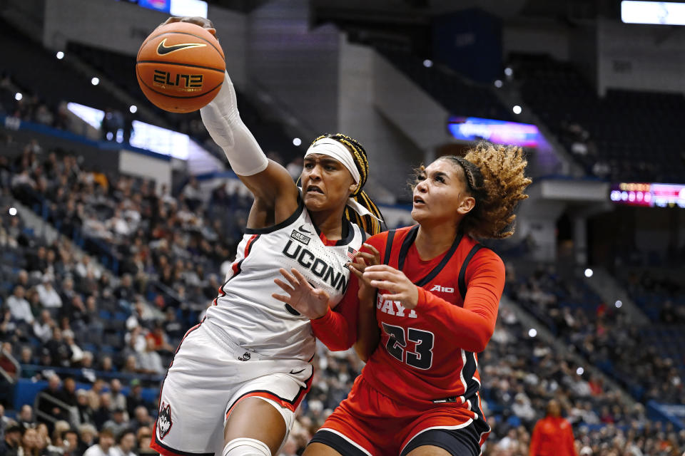 UConn forward Aaliyah Edwards reaches for a rebound against Dayton forward Mariah Perez (23) in the second half of an NCAA college basketball game, Wednesday, Nov. 8, 2023, in Hartford, Conn. (AP Photo/Jessica Hill)