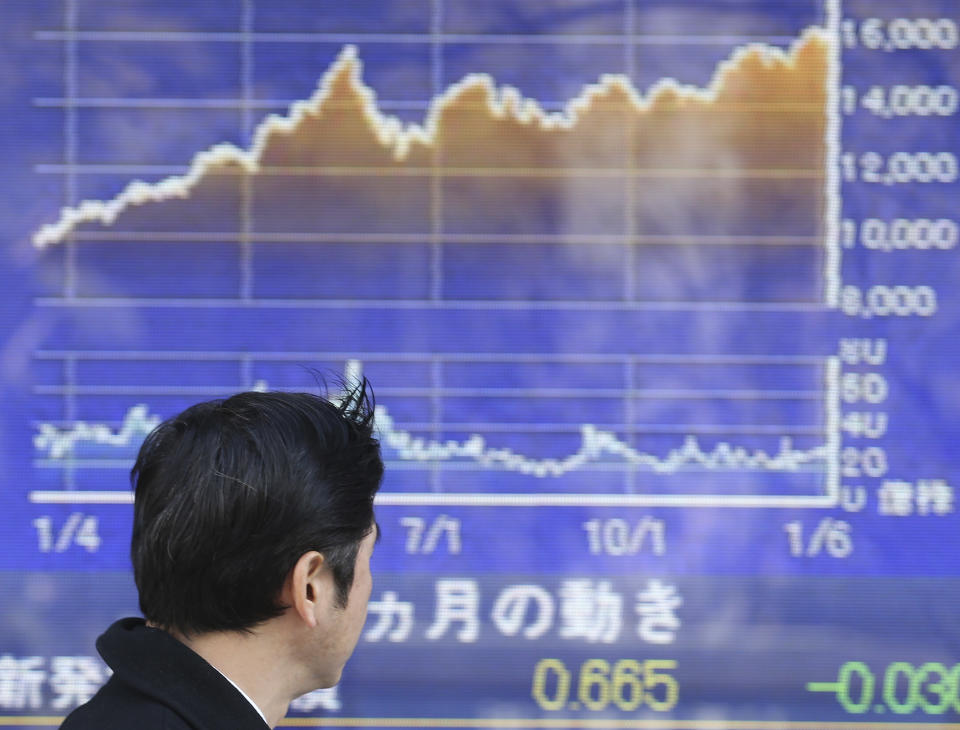 A man looks at an electronic stock board of a securities firm in Tokyo, Tuesday, Jan. 14, 2014. Most Asian stock markets sank Tuesday, led by Japan, following a big sell-off in the U.S. (AP Photo/Koji Sasahara)