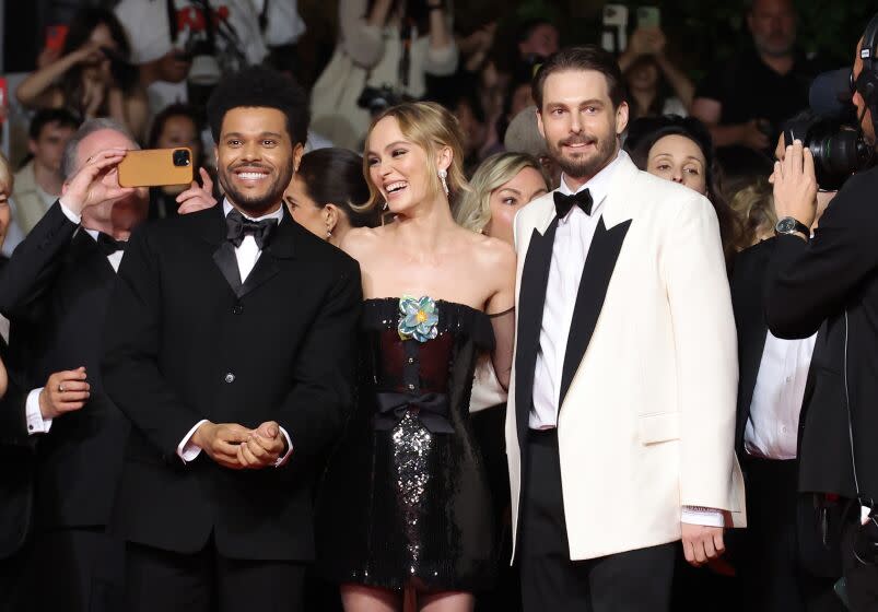 CANNES, FRANCE - MAY 22: (L-R) Abel "The Weeknd" Tesfaye, Lily-Rose Depp and Sam Levinson attend the "The Idol" red carpet during the 76th annual Cannes film festival at Palais des Festivals on May 22, 2023 in Cannes, France. (Photo by Mike Coppola/Getty Images)