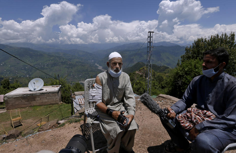 Abdul Aziz, who was injured when shrapnel from an Indian mortar wounded his arm, talks to journalists in Chiri Kot sector near the Line of Control, that divides Kashmir between Pakistan and India, Wednesday, July 22, 2020. Villagers living along a highly militarized frontier in the disputed region of Kashmir have accused India of “intentionally targeting” civilians, but they are vowing that they would never leave their areas. Villagers say the fear of death is no longer present in their hearts after spending so many years in a state of shock and uncertainty. (AP Photo/Anjum Naveed)