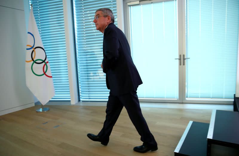 IOC President Bach leaves after a news conference in Lausanne