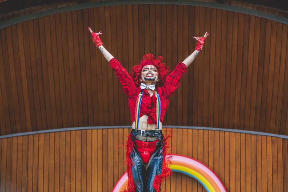 Sylvester Stalletto, a drag king from Victoria, B.C., raises his hands triumphantly at a pride event in nearby Sidney, B.C. in June 2024. 