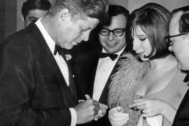 National Archive/Newsmakers John F. Kennedy signs an autograph for Barbra Streisand after the White House Correspondents' Dinner on May 24, 1963