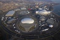 An aerial view from a helicopter shows the Olympic Park under construction in the Adler district of the Black Sea resort city of Sochi, December 23, 2013. Sochi will host the 2014 Winter Olympic Games in February. The view shows (clockwise from R, top) the "Fisht" Olympic Stadium, the "Shayba" Arena, the "Bolshoy" Ice Dome, the "Ice Cube" Curling center, the "Adler Arena" and the "Iceberg" Skating Palace. Picture taken December 23, 2013. REUTERS/Maxim Shemetov (RUSSIA - Tags: CITYSCAPE BUSINESS CONSTRUCTION SPORT OLYMPICS)