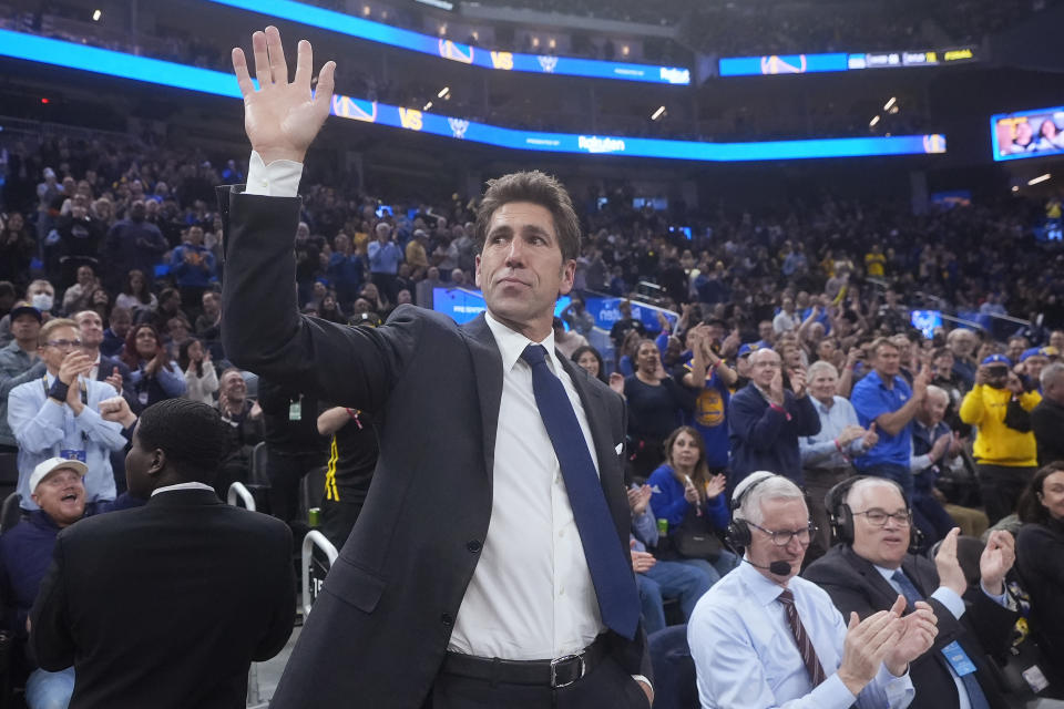 Former Golden State Warriors general manager Bob Myers waves while being honored during the first half of an NBA basketball game between the Warriors and the Milwaukee Bucks in San Francisco, Wednesday, March 6, 2024. (AP Photo/Jeff Chiu)