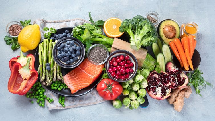 Uncooked healthy foods, including fruit, veg and fish.