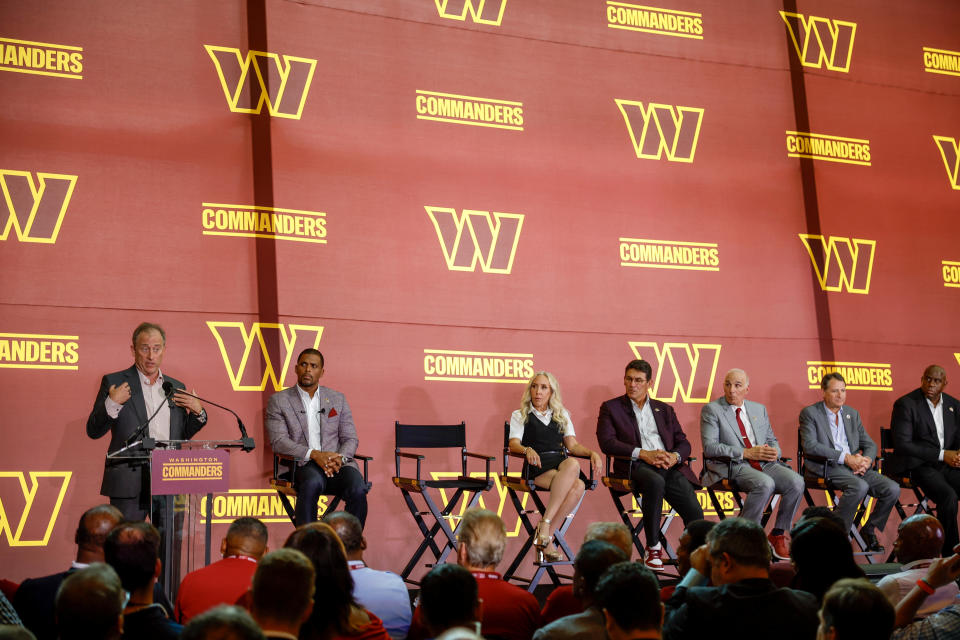 Josh Harris (L), a new owner of the Washington Commanders, delivers remarks during a news conference introducing the team's new ownership at FedExField on July 21 in Landover, Maryland. (Photo by Tasos Katopodis/Getty Images)