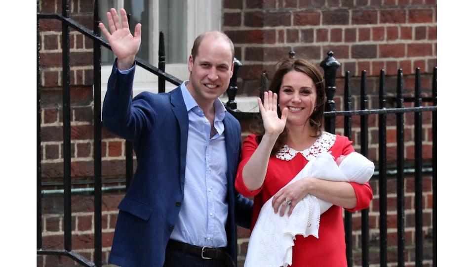 Prince William and Kate Middleton waving with Kate carrying Prince Louis