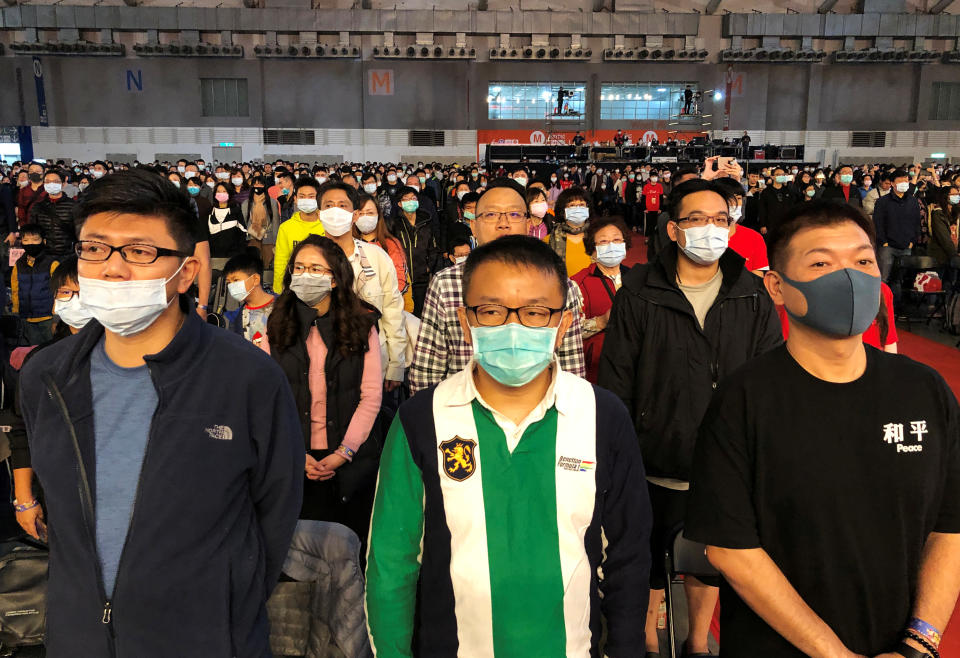 Foxconn employees wearing masks attend the company's year-end gala in Taipei