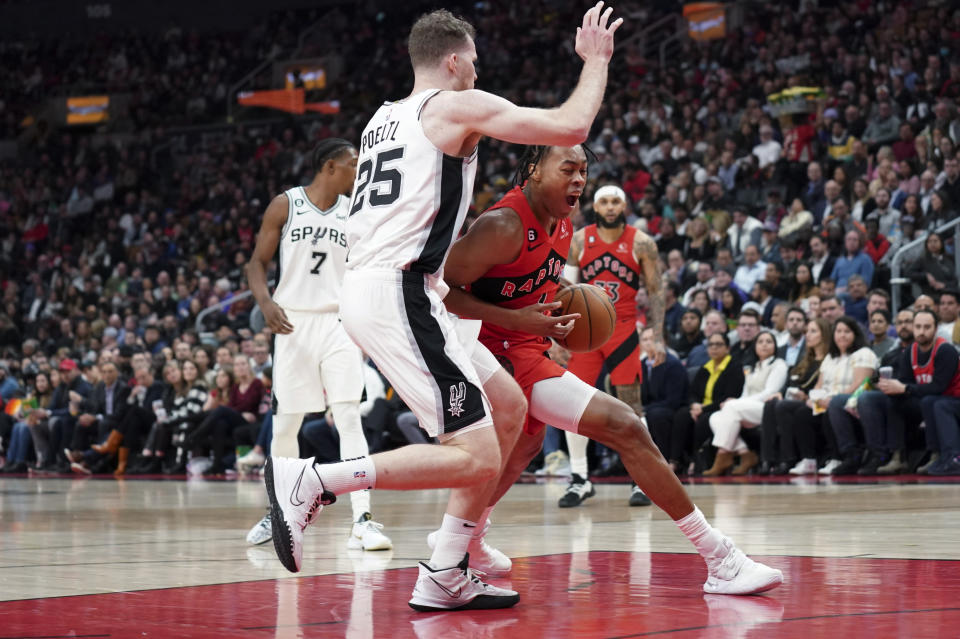 Toronto Raptors forward Scottie Barnes (4) pushes past San Antonio Spurs centre Jakob Poeltl (25) during the first half of an NBA basketball game Wednesday, Feb. 8, 2023, in Toronto. (Arlyn McAdorey/The Canadian Press via AP)