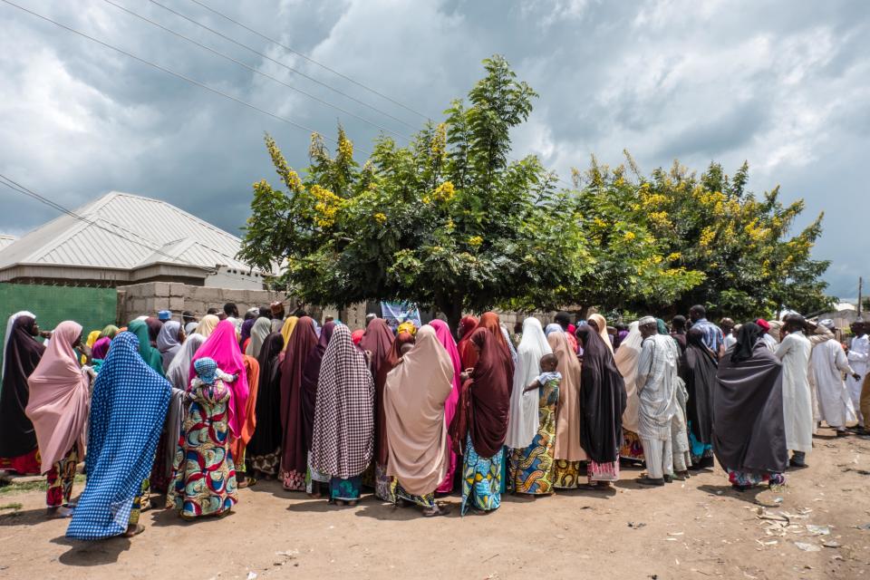 A crowd gathers for Mercy Corps' e-voucher distribution in a neighborhood in Biu, Borno State. The vouchers are worth 17,000 Naira/month (for eight months) and can be used to buy food in local markets.