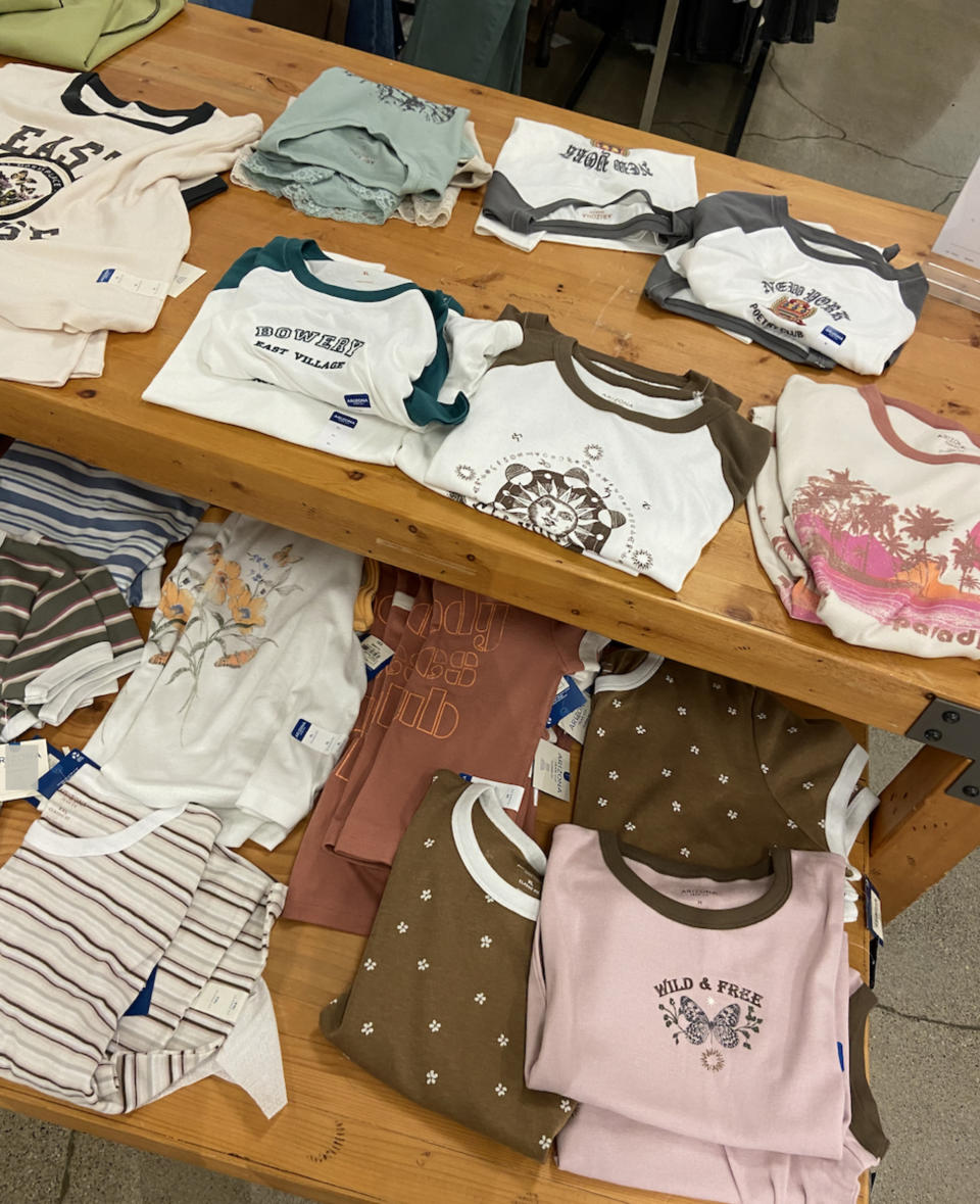 An assortment of graphic baby tees reminiscent of the teen store Delia's