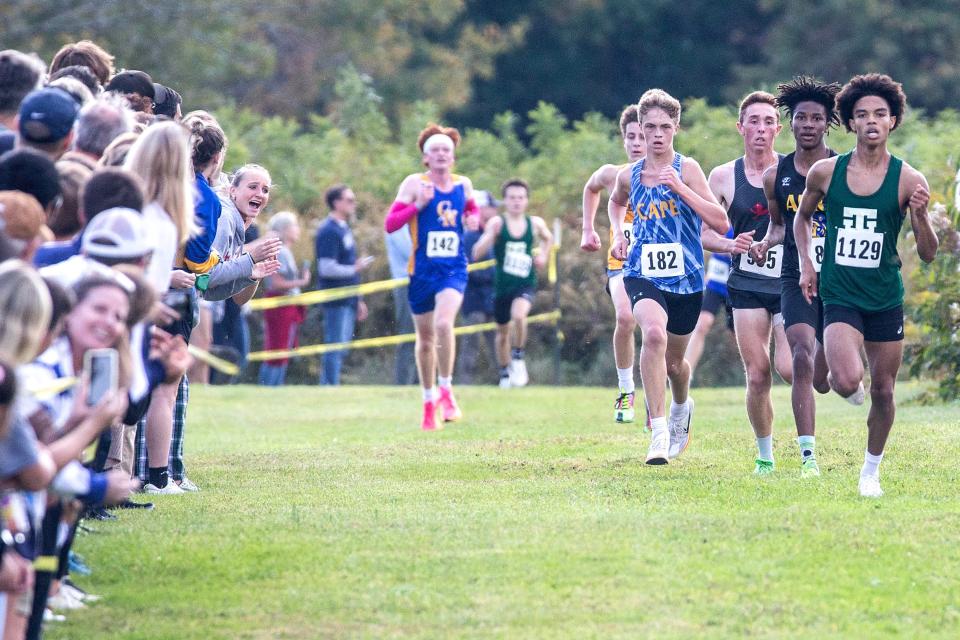 The top five boys varsity runners approach the finish line during the 2023 Joe O'Neill Invitational at Bellevue State Park Thursday, Oct. 19, 2023. Caesar Rodney senior Patrick Craig is to the left.