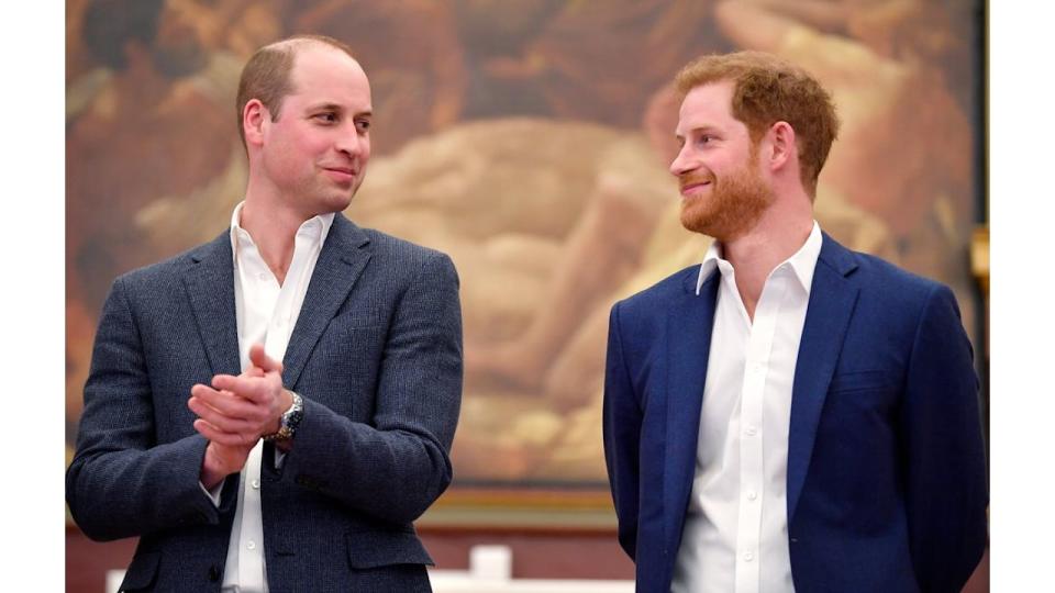 Prince William and Prince Harry smirking at each other