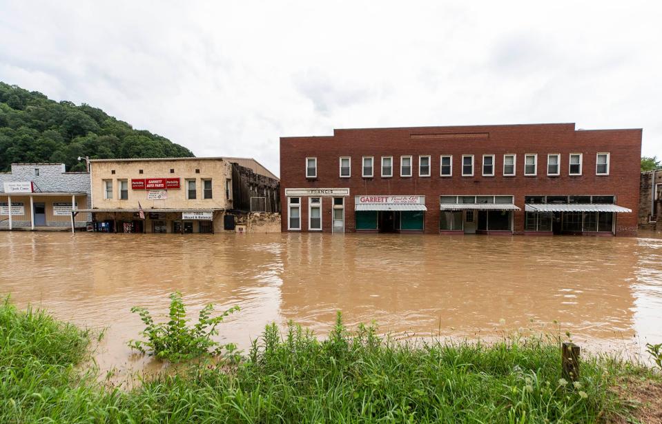 Flood waters rise along Right Beaver Creek, submerging business in the town of Garrett, Kentucky, following a day of heavy rain. July 28, 2022